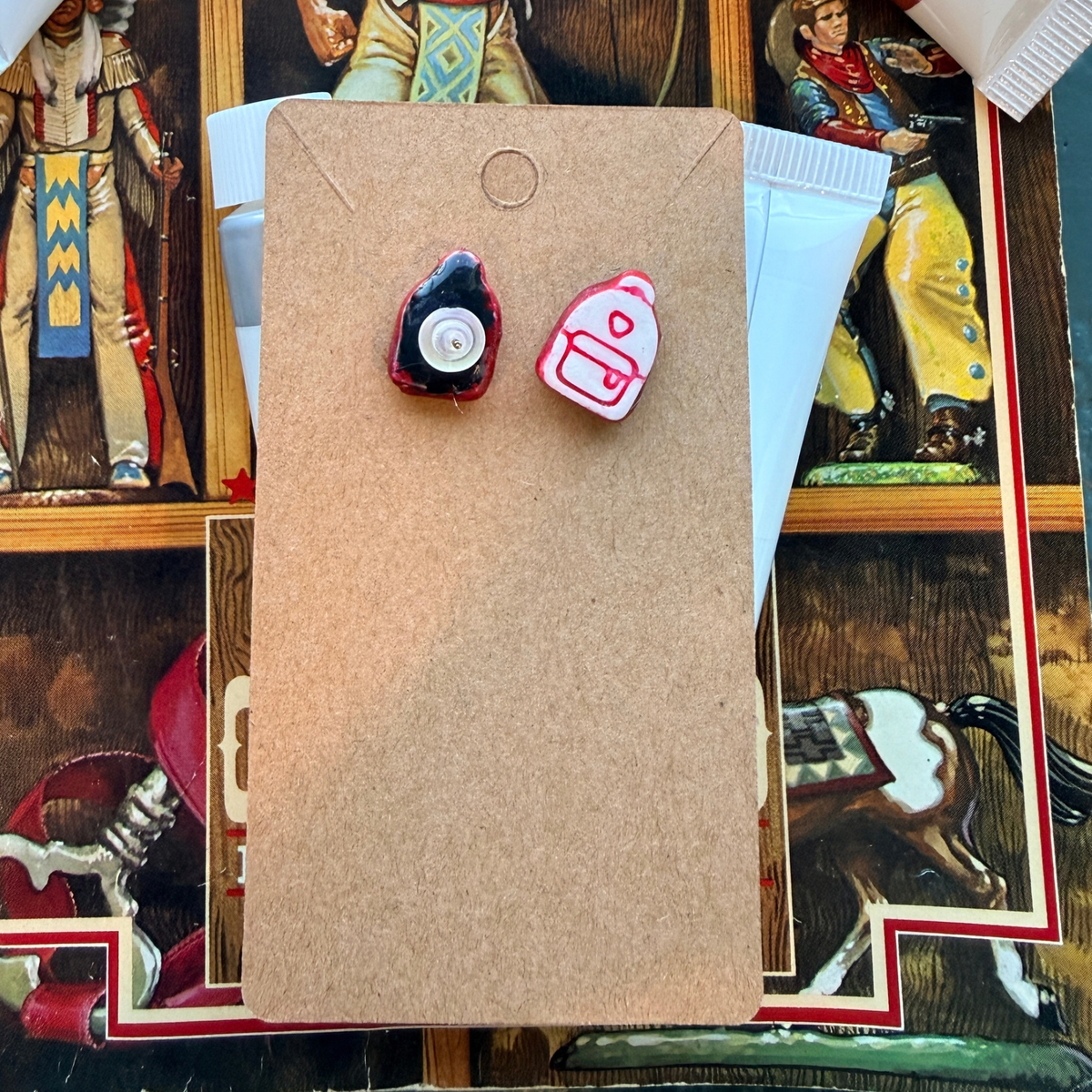 Front and back of pink backpack stud earrings, showing the post and round backing.