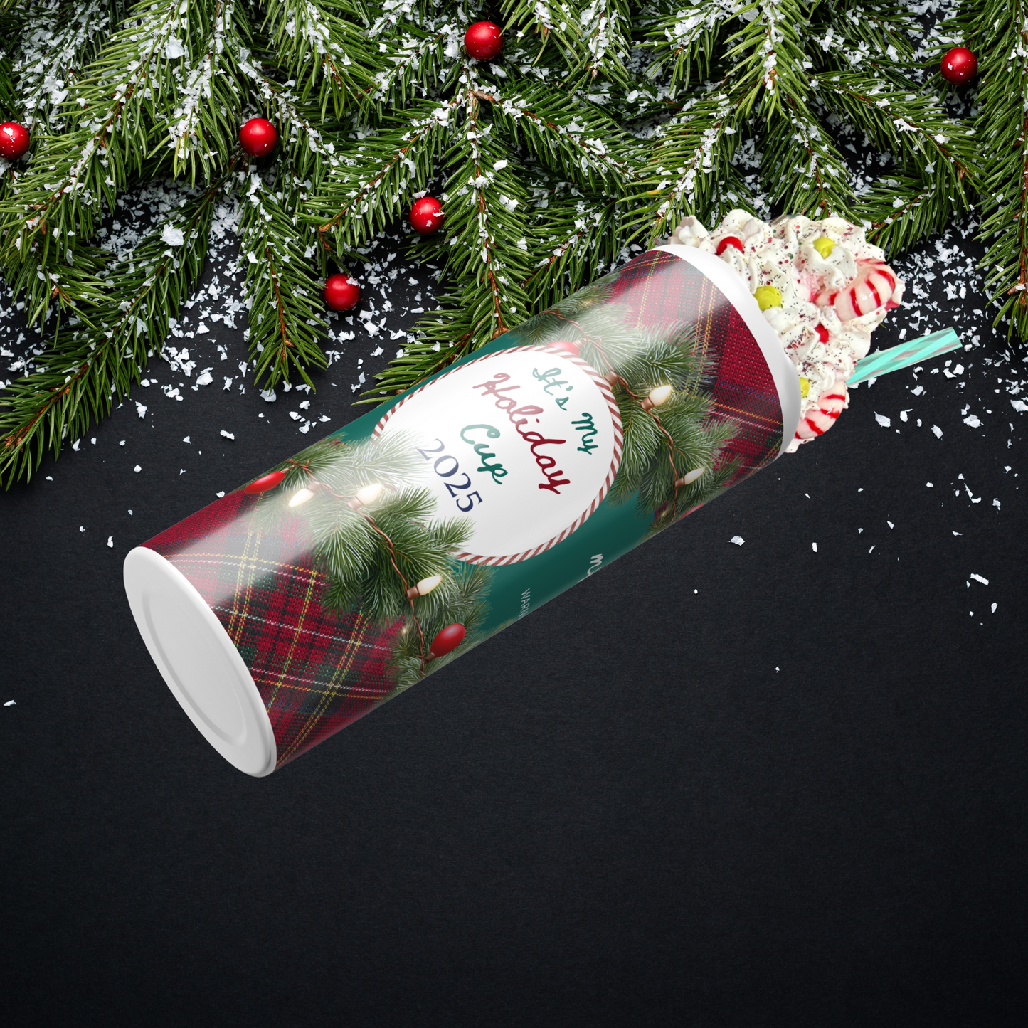 Christmas-themed tumbler with festive design on a black background with pine branches.
