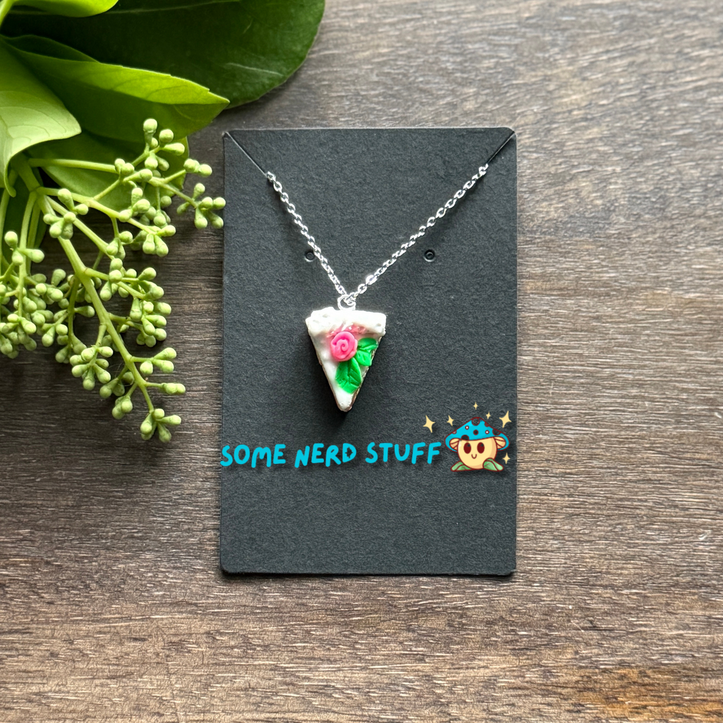 Pretty in Pink Polymer Clay necklace top view with pink rose and green petals