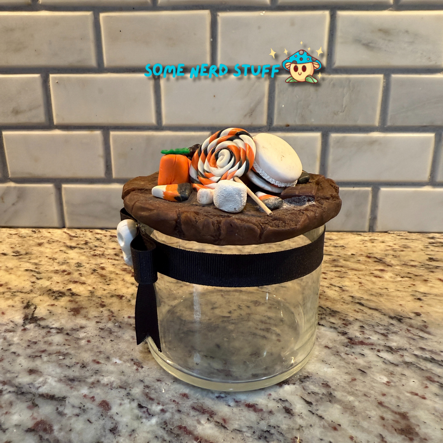 Spooktacular Stash Jar made with polymer clay including macarons, marshmellos, candy lollipop, candy corn, and candy corn pumpkin.