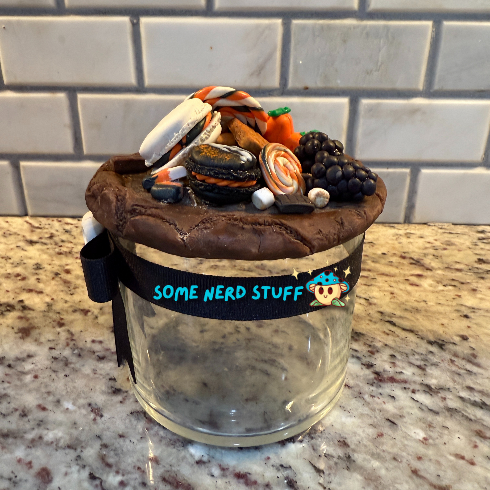 Spooktacular Stash Jar made with polymer clay including macarons, marshmellos, candy lollipop, candy corn, and candy corn pumpkin right side.