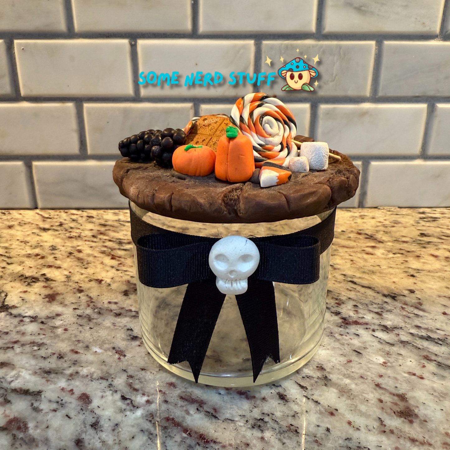 Spooktacular Stash Jar made with polymer clay including macarons, marshmellos, candy lollipop, candy corn, and candy corn pumpkin front skull