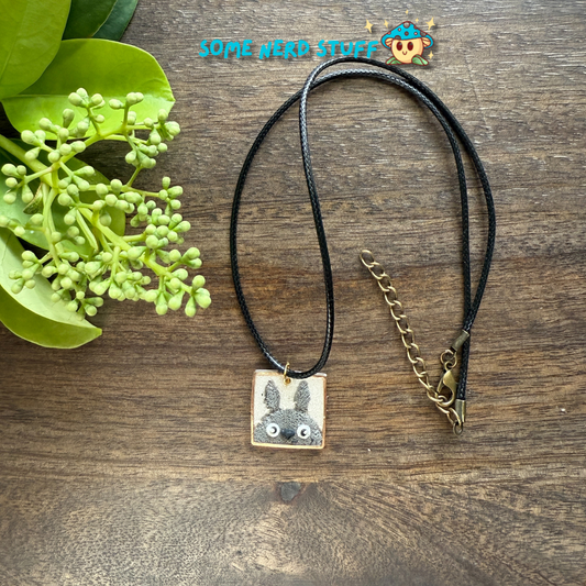 Polymer Clay Charm totoro in a metal square frame handing from a necklace with clasps made by SomeNerdStuff