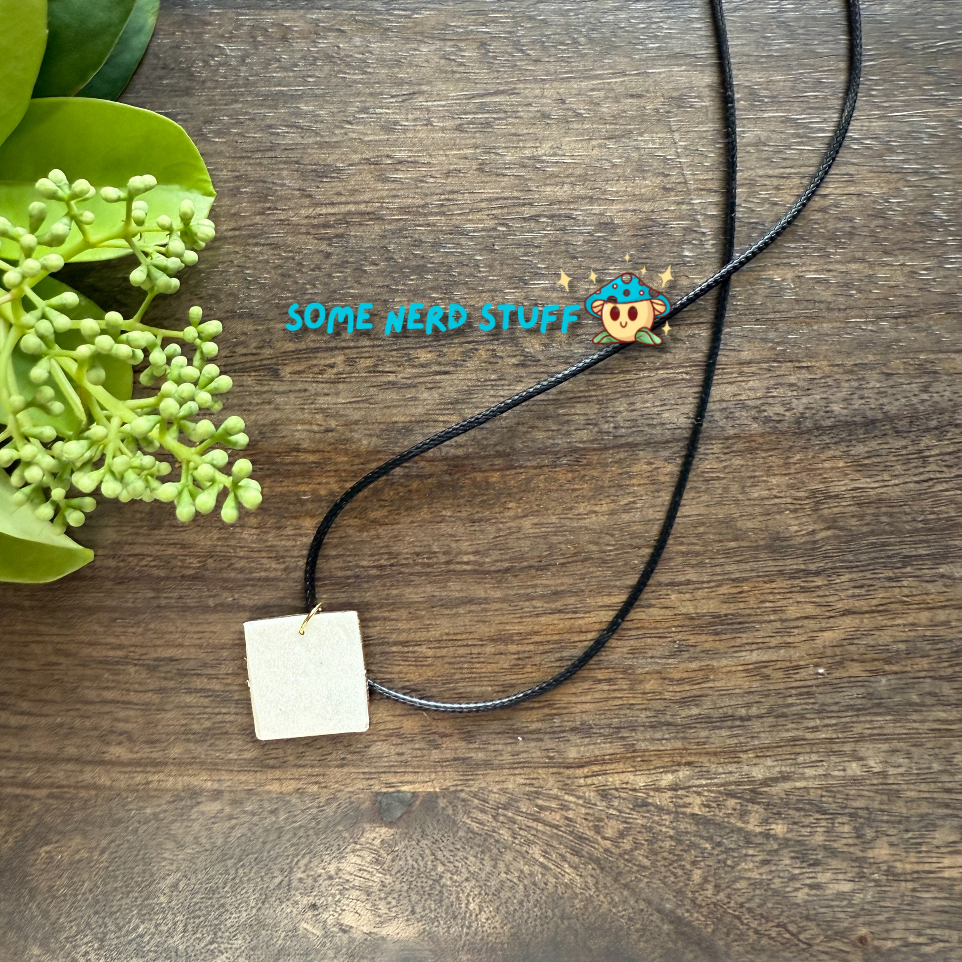 Polymer Clay Charm totoro in a metal square frame handing from a necklace with clasps made by SomeNerdStuff
