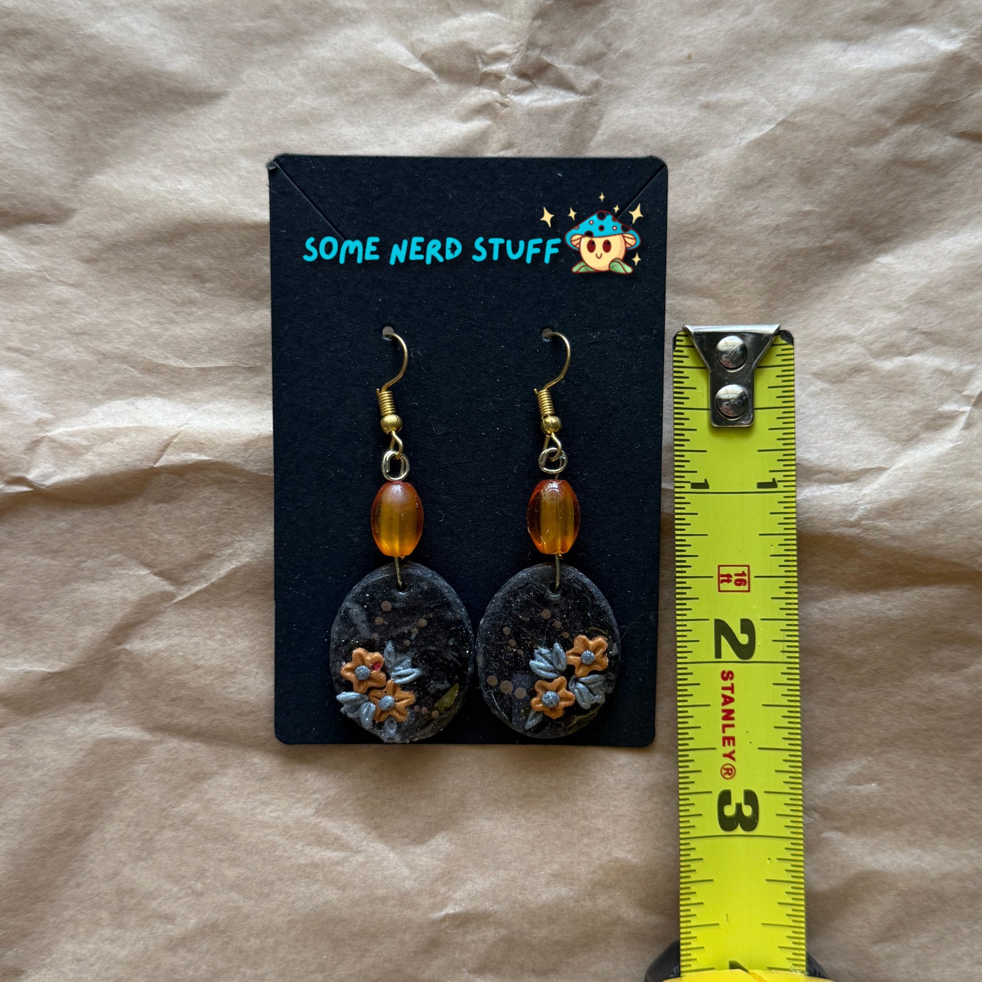 Faux Stone Polymer Clay Earrings with accent flowers and amber beads shown with measuring tape made by SomeNerdStuff