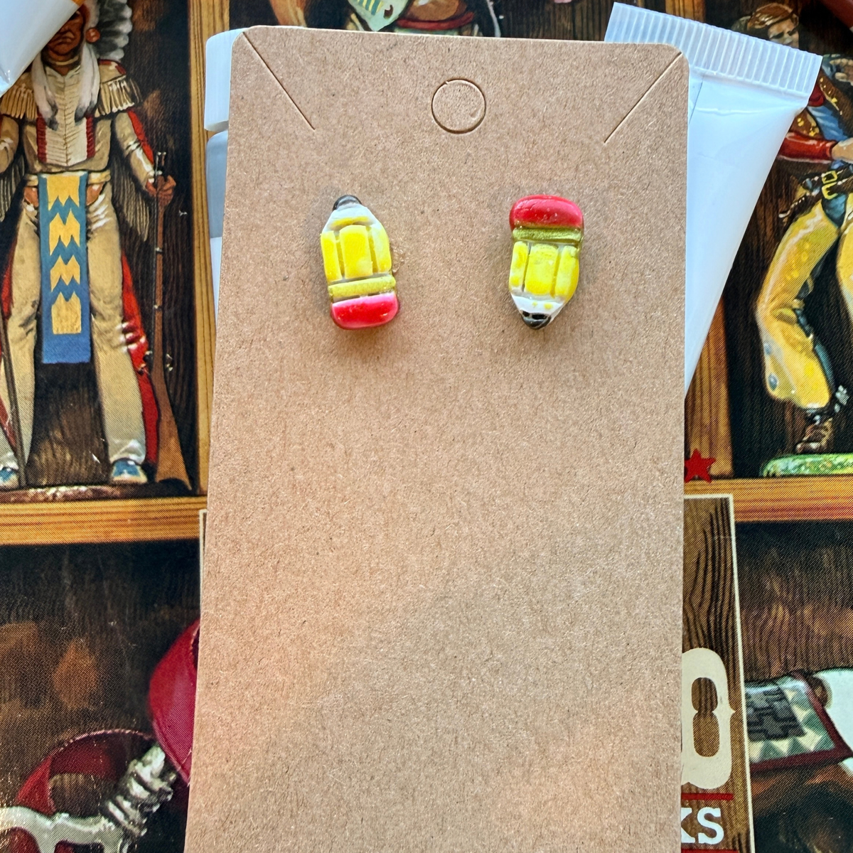 Matching baby pencil stud earrings with yellow bodies, red eraser details, and dark points.