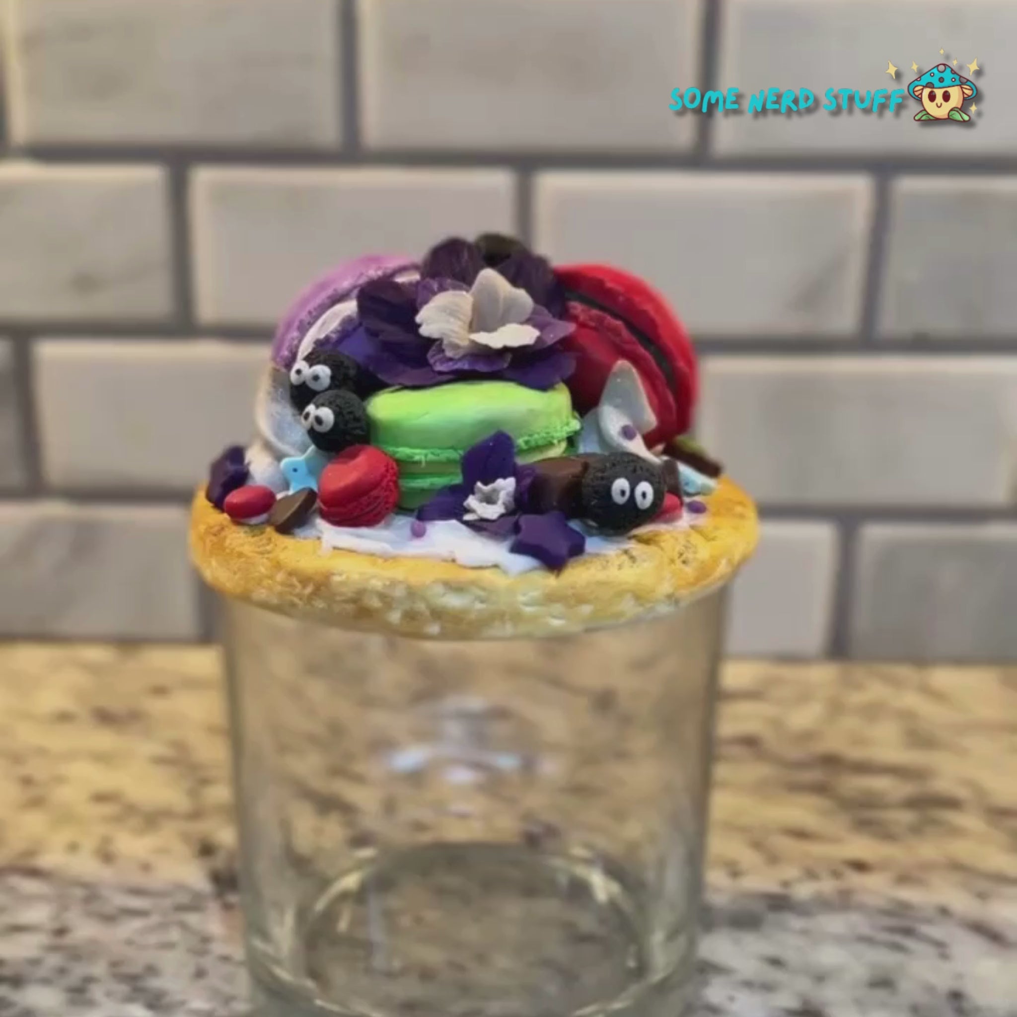 Soot Sprite Stash Jar topped with polymer clay macarooms, Soot Sprites, chocolate pieces, orchids.