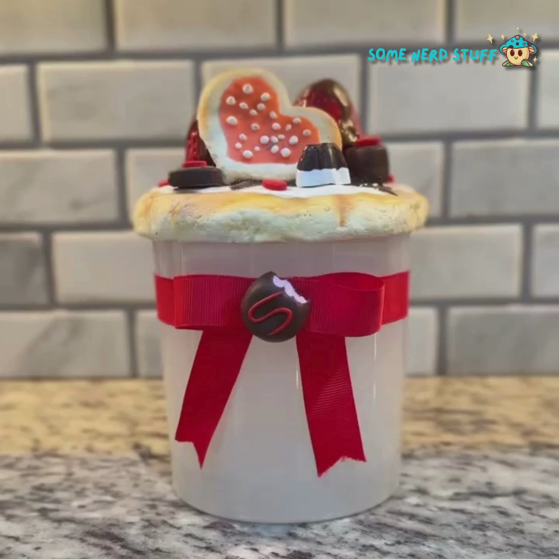 Stash Jar or Cookie Jar that is made of polymer clay over a glass jar. Decorated with clay macarons, chocolates, and dripping in chocolate glaze Video. Made by SomeNerdStuff.